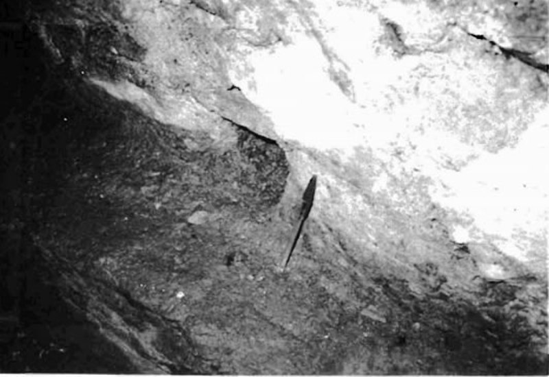 B&W picture of a drainage channel at the bottom of a qanat tunnel rendered inactive due to CaCO3 deposits.